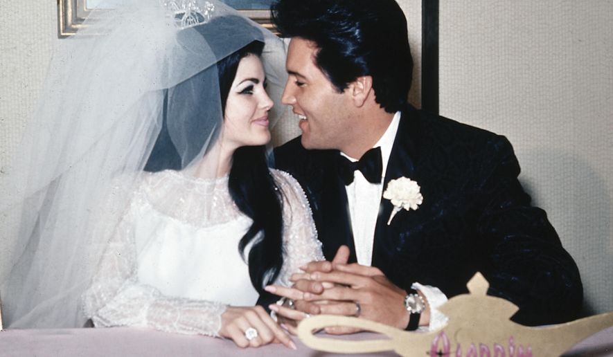 FILE - In this May 1, 1967, file photo, singer Elvis Presley and his bride, the former Priscilla Beaulieu, appear at the Aladdin Hotel in Las Vegas, after their wedding. Priscilla Presley opened up about her life with Elvis during a Nov. 16, 2016, interview on British chat show, “Loose Women,” on the ITV network. (AP Photo/File)
