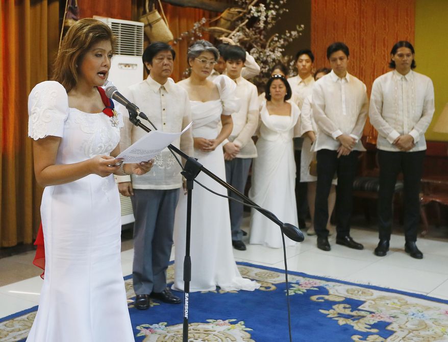 Gov. Imee Marcos reads her family's statement after the late Ferdinand Marcos, her father, was buried at the Heroes' Cemetery Friday, Nov. 18, 2016, in Pasay, Philippines. Ferdinand Marcos was buried at a heroes' cemetery Friday in a secrecy-shrouded ceremony, police officials said, despite growing opposition after the Supreme Court ruled that one of Asia's most infamous tyrants can be entombed in the hallowed grounds. (AP Photo/Bullit Marquez)