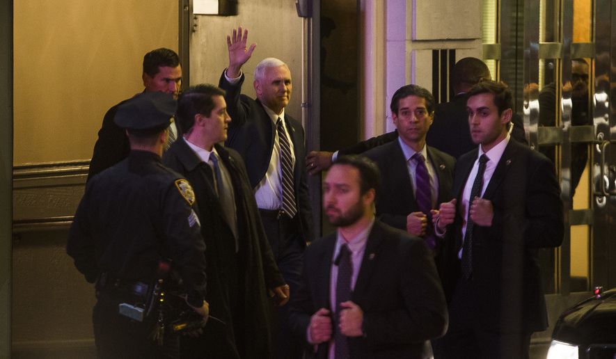 Vice President-elect Mike Pence, top center, leaves the Richard Rodgers Theatre after a performance of &quot;Hamilton,&quot; in New York, Friday, Nov. 18, 2016. (AP Photo/Andres Kudacki)