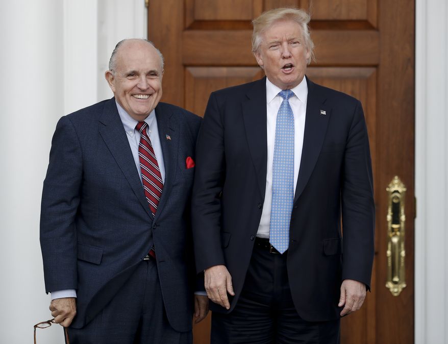 President-elect Donald Trump, right, and former New York Mayor Rudy Giuliani pose for photographs as Giuliani arrives at the Trump National Golf Club Bedminster clubhouse in Bedminster, N.J., on Nov. 20, 2016. (AP Photo/Carolyn Kaster) **FILE**