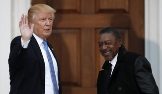 President-elect Donald Trump, left, stands with BET founder Robert Johnson at the Trump National Golf Club Bedminster clubhouse, Sunday, Nov. 20, 2016, in Bedminster, N.J.. (AP Photo/Carolyn Kaster) ** FILE **