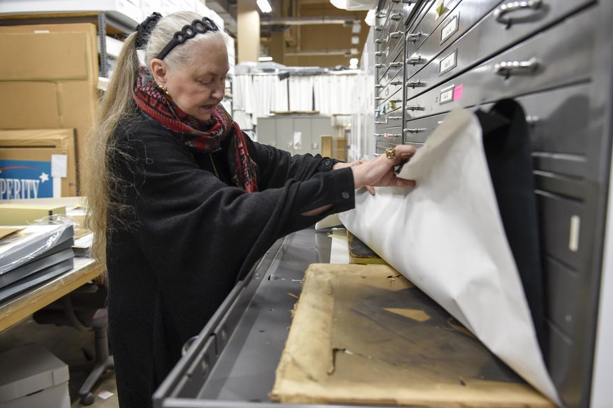 Tennessee State Museum Executive Director Lois Riggins-Ezzell looks through exhibits in storage on Nov. 15, 2016, in Nashville, Tenn. For the past 35 years, Riggins-Ezzell has curated the story of Tennessee's history, spirit and heritage through the objects that shaped it. (Lacy Atkins/The Tennessean via AP)