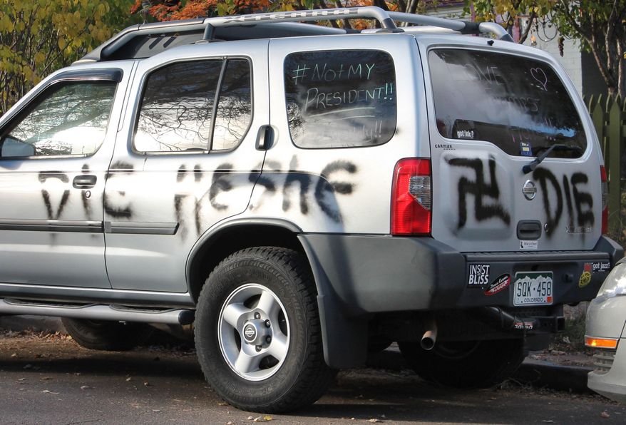 This Wednesday, Nov. 16, 2016 photo provided by Denverite.com shows spray painted anti-transgender graffiti on the car of Amber Timmons, a transgender woman, in Denver. After the sweeping Republican election victory on Nov. 9, 2016, transgender people "are concerned for their safety, survival and legal rights in the coming years," said Chase Strangio, an attorney with the American Civil Liberties Union who often works on transgender issues. (Ashley Dean/Denverite.com via AP)