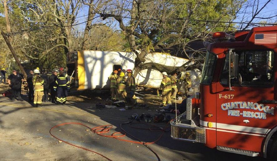 In this photo provided by the Chattanooga Fire Department via Chattanooga Times Free Press, Chattanooga Fire Department members work the scene of a fatal elementary school bus crash in Chattanooga, Tenn., Monday, Nov. 21, 2016. In a news conference Monday, Assistant Chief Tracy Arnold said there were multiple fatalities in the crash. (Bruce Garner/Chattanooga Fire Department via Chattanooga Times Free Press via AP)