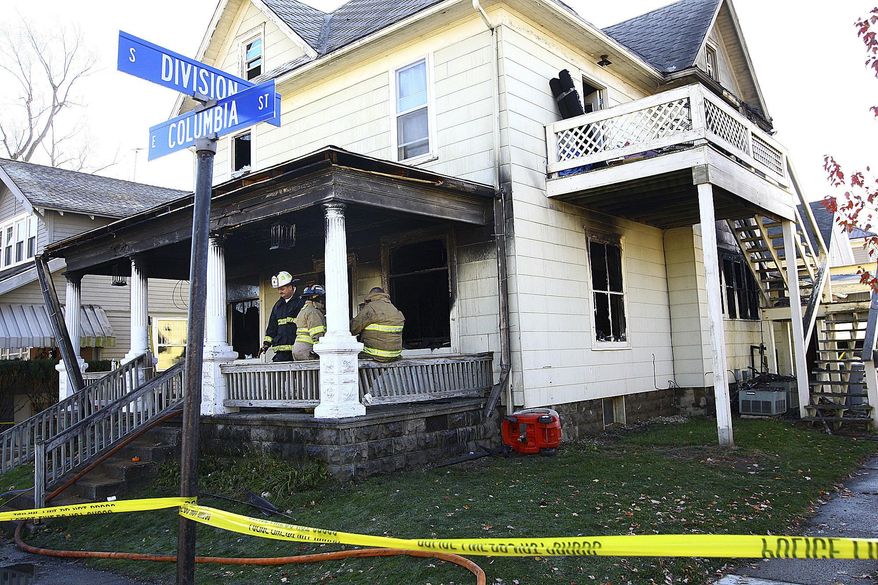 Firefighters work at a house where four children died in a house fire in the 100 block of East Columbia Street in Flora, Ind., on Monday morning, Nov. 21, 2016. The fire also injured their mother and two law enforcement officers who tried to rescue the youngsters but were driven back by intense flames and smoke, a fire official said Monday. (Tim Bath/Kokomo Tribune via AP)