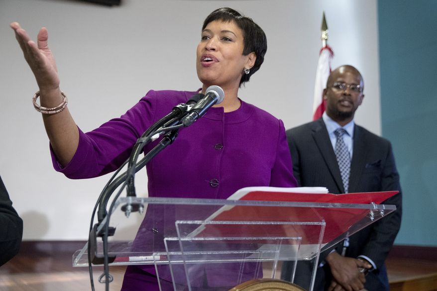 Washington Mayor Muriel Bowser, left, speaks at a news conference at Easter High School in Washington, Tuesday, Nov. 22, 2016, to announce Antwan Wilson, right, the new Washington Schools Chancellor. (AP Photo/Andrew Harnik) ** FILE **