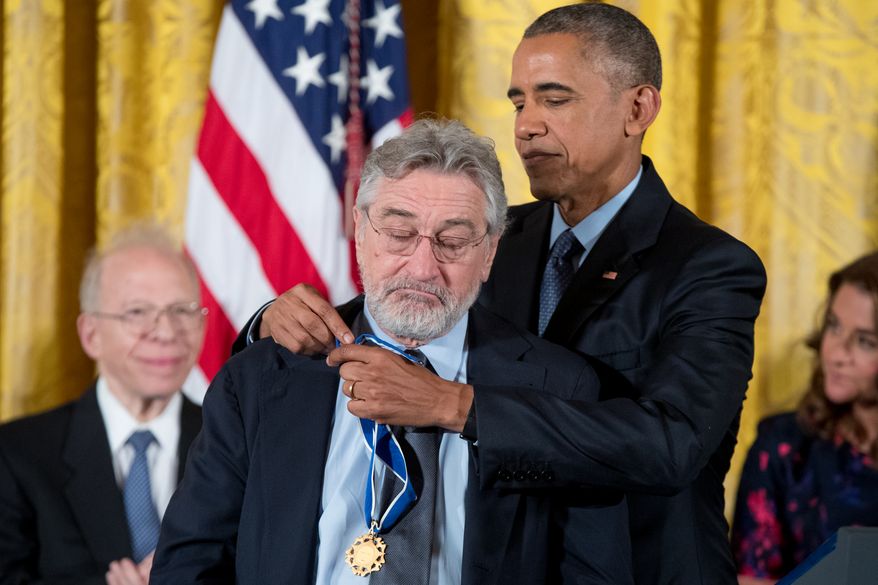 President Barack Obama presents the Presidential Medal of Freedom to actor Robert De Niro during a ceremony in the East Room of the White House, Tuesday, Nov. 22, 2016, in Washington. Obama is recognizing 21 Americans with the nation's highest civilian award, including giants of the entertainment industry, sports legends, activists and innovators. (AP Photo/Andrew Harnik)
