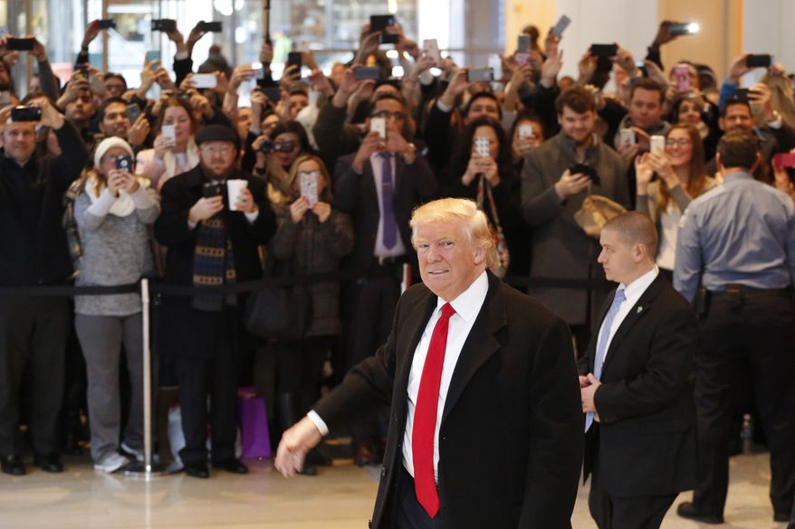 President-elect Donald Trump walks past a crowd as he leaves the New York Times building following a meeting, Tuesday, Nov. 22, 2016, in New York. (AP Photo/Mark Lennihan)