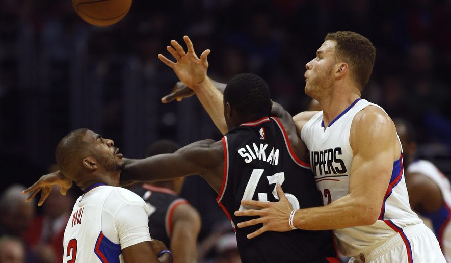 Los Angeles Clippers guard Chris Paul, left, and forward Blake Griffin, right, compete for the ball with Toronto Raptors forward Pascal Siakam, center, during the first half of an NBA basketball game in Los Angeles, Monday, Nov. 21, 2016. (AP Photo/Alex Gallardo)