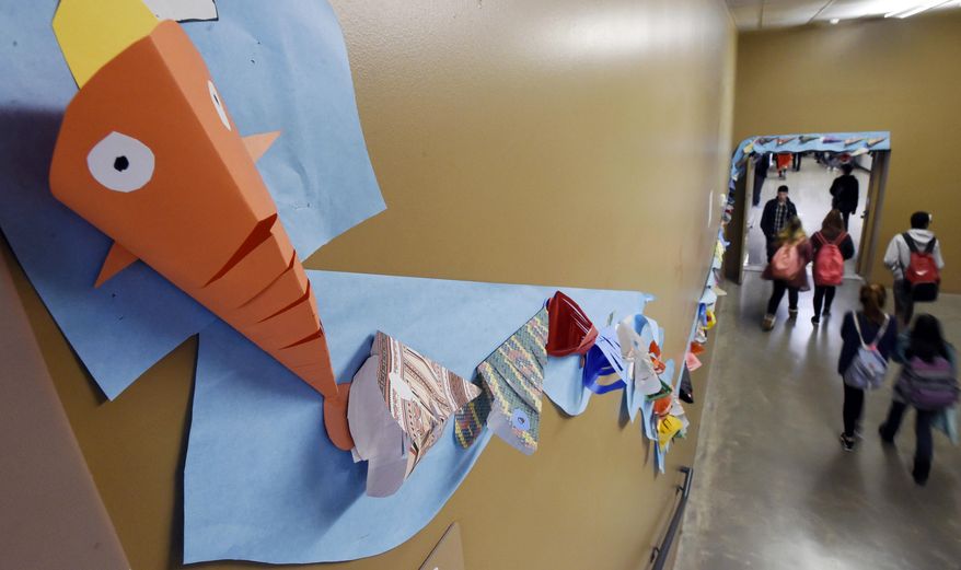 ADVANCE FOR WEEKEND EDITIONS - In this Nov. 17, 2016, photo, a stream of koi winds through the halls at the Discovery Canyon Campus in Colorado Springs, Colo., each fish handmade by students, teachers, faculty and parents. Last year, five kids committed suicide from the Discovery Canyon Campus school. The name of the art project is "Keep Swimming" and signifies that each student has someone behind them to help them through rough times. (Jerilee Bennett/The Gazette via AP)