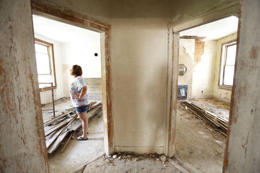 In this Nov. 1, 2016 photo, Genevieve Busby stands inside the Chalmers Institute, in Holy Springs, Miss. Busby and her family have gotten involved in the rehabilitation of the the institute that was built in 1837. (Thomas Wells/The Northeast Mississippi Daily Journal via AP)