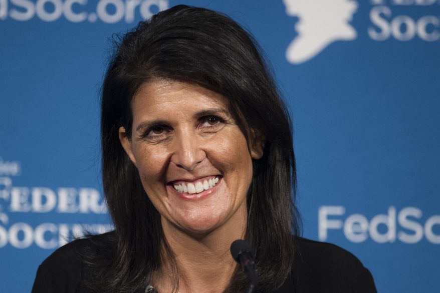 FILE - In this Friday, Nov. 18, 2016 photo, South Carolina Gov. Nikki Haley smiles while speaking at the Federalist Society's National Lawyers Convention in Washington. President-elect Donald Trump has chosen Haley as U.S. ambassador to the United Nations, and he will treat the ambassadorship as a Cabinet-level position, according to two sources familiar with Trump's decision who requested anonymity to discuss the decision and its announcement. Haley, an outspoken Trump critic throughout much of the presidential race, would become his first female - and first nonwhite - Cabinet-level official if confirmed by the Senate. (AP Photo/Cliff Owen, File)
