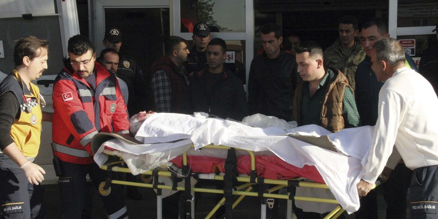 Medical officers carry one of wounded Turkish soldiers at the emergency service of a local hospital in Gaziantep, Turkey, Thursday, Nov. 24, 2016. Three Turkish soldiers were killed and 10 were wounded in northern Syria on Thursday in what the Turkish military said was a pre-dawn airstrike believed to have been carried out by Syrian government forces. Turkish authorities have banned distribution of images relating to the Syria attack within Turkey. (IHA via AP )
