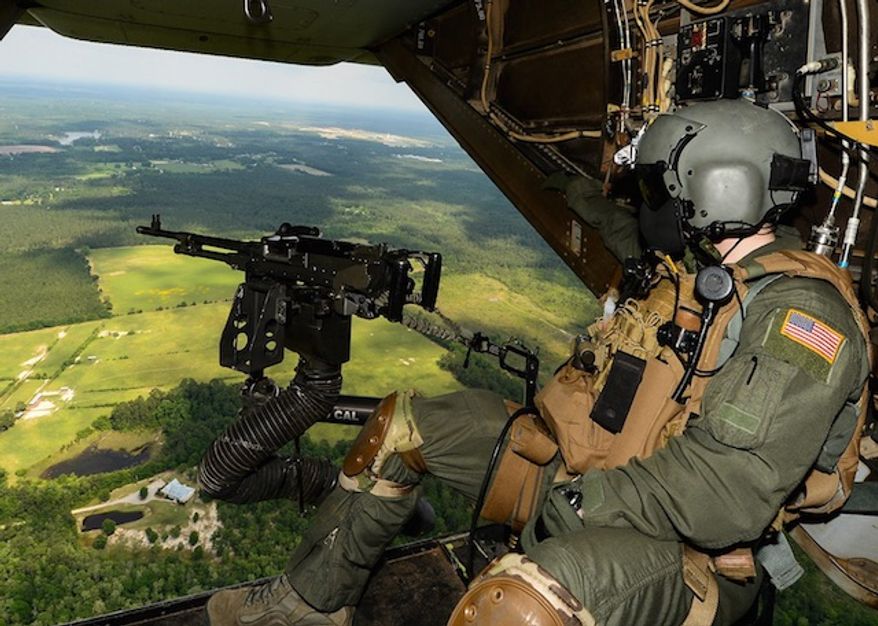 A flight engineer with 8th Special Operations Squadron scans for potential threats during a CV-22 Osprey training flight May 20, 2014. (Facebook, Air Force Special Operations Command)