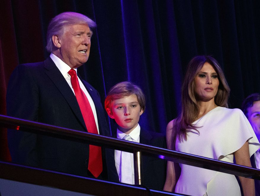 In this Nov. 9, 2016, file photo, President-elect Donald Trump, left, arrives to speak at an election night rally with his son Barron and wife Melania, in New York. Breaking with tradition, Donald Trump will move into the White House after the inauguration while wife Melania and 10-year-old son Barron plan to remain in New York City until at least the end of the school year. (AP Photo/Evan Vucci, File)