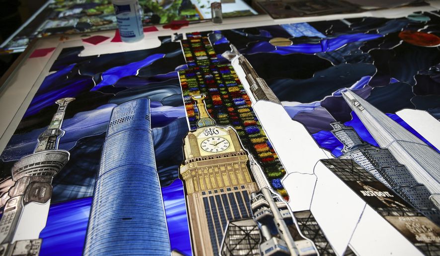 In a Friday, Nov. 4, 2016 photo, pieces of art glass are assembled into panels for the Roots of Knowledge, a 200-foot long stained glass installation for Utah Valley University, at Holdman Studios in Lehi, Utah. The university announced a $1.5 million donation from philanthropists Marc and Deborah Bingham that will enable the completion of the massive stained glass installation. (Spenser Heaps/The Deseret News via AP)