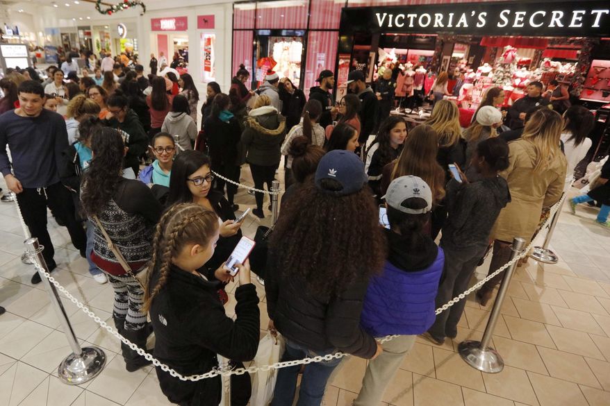 Shoppers queue up in front of Victoria's Secret at the Dartmouth Mall on Black Friday, in Dartmouth, Mass., Nov. 25, 2016. Stores open their doors Friday for what is still one of the busiest days of the year, even as the start of the holiday season edges ever earlier. (Peter Pereira/Standard Time/SCMGs via AP)