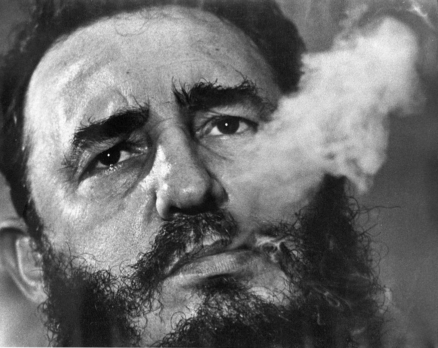In this March 1985 file photo, Cuba's leader Fidel Castro exhales cigar smoke during an interview at the presidential palace in Havana, Cuba. Castro has died at age 90. President Raul Castro said on state television that his older brother died late Friday, Nov. 25, 2016. (AP Photo/Charles Tasnadi, File)