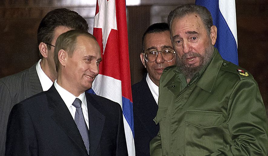 FILE - In this Thursday, Dec. 14, 2000, file photo, Russian President Vladimir Putin, left, and Cuban President Fidel Castro talk before signing agreements in Havana, Cuba. Castro, who led an improbable rebel victory, embraced Soviet-style communism long after the collapse of the Soviet Union and defied the power of 10 U.S. presidents, died at age 90, Friday, Nov. 25, 2016. (AP Photo/Alexander Zemlianichenko, File)