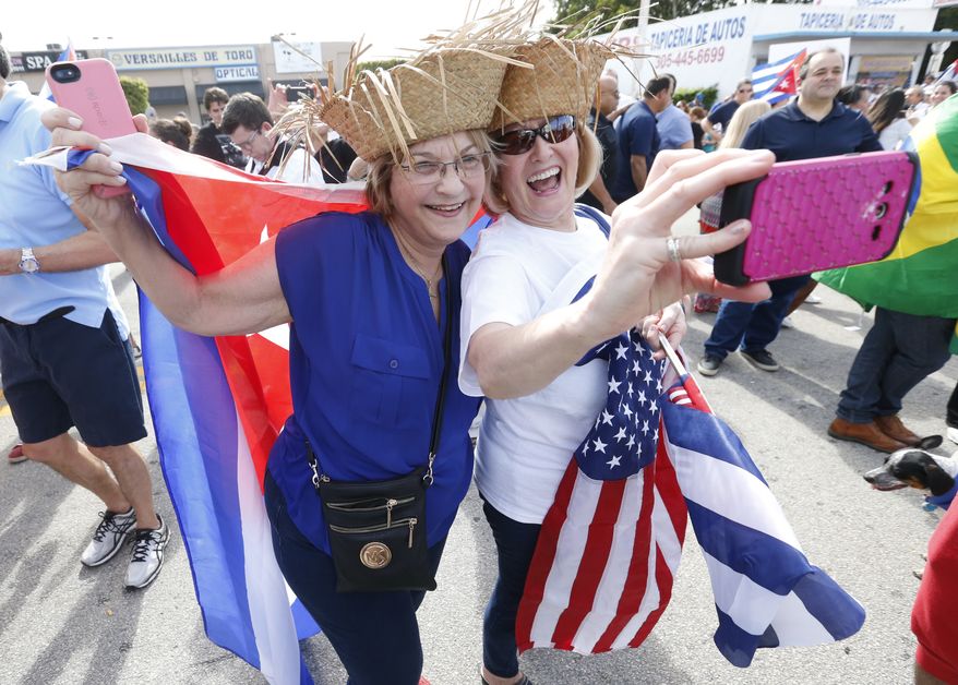 Carmen Romanach, left, and Maria Gregorian take a selfie as they join members of the Cuban community as they react to the death of Fidel Castro, Saturday, Nov. 26, 2016, in the Little Havana area in Miami. &quot;We are not celebrating a death,&quot; said Romanach, &quot;We are celebrating a new hope for Cuba.&quot; (AP Photo/Wilfredo Lee)
