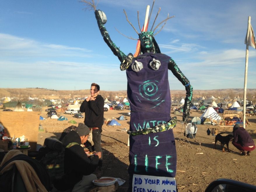 A sculpture stands at an encampment where protesters of the Dakota Access oil pipeline have been gathered for months, Saturday, Nov. 26, 2016, near Cannon Ball, N.D. Protest organizers said that they have a right to stay on the land. Their statement comes a day after the U.S. Army Corps of Engineers told they would have to leave by Dec. 5. (AP Photos/James MacPherson)