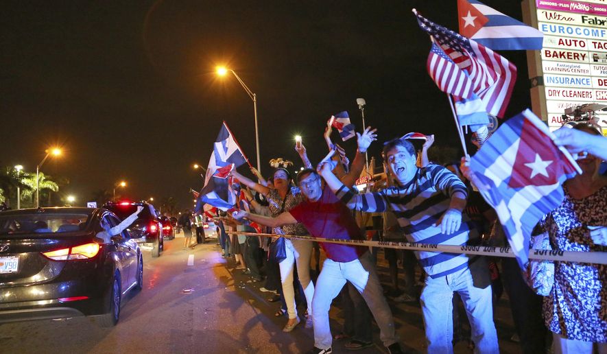 The Cuban community in Miami celebrates the announcement that Fidel Castro died in front of La Carreta Restaurant, early Saturday, Nov. 26, 2016, in Miami. Within half an hour of the Cuban government’s official announcement that former President Fidel Castro had died, Friday, Nov. 25, 2016, at age 90, Miami’s Little Havana teemed with life - and cheers. (David Santiago/El Nuevo Herald via AP)