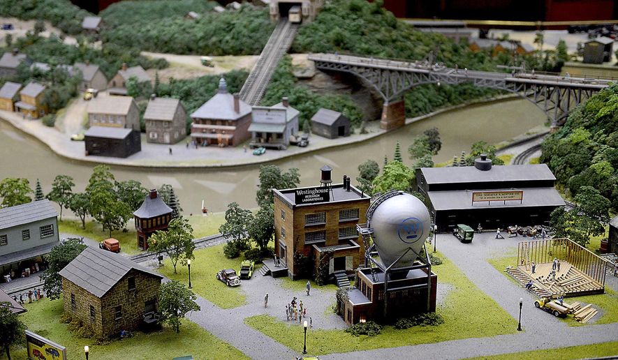 This Thursday, Nov. 17, 2016 photo shows a model of the Westinghouse Atom Smasher, the newest addition to the Carnegie Science Center's Miniature Railroad & Village, in Pittsburgh. (Michael Henninger /Pittsburgh Post-Gazette via AP)