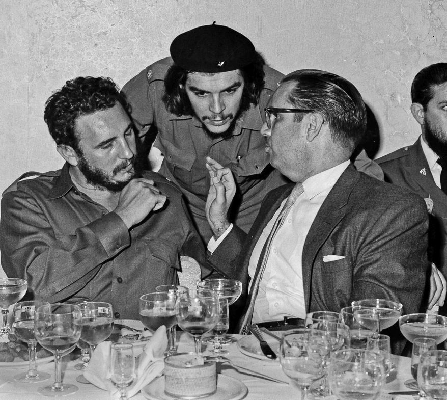 FILE - In this 1960 file photo, Cuba's revolutionary hero Ernesto "Che" Guevara, center, Cuba's leader Fidel Castro, left, and Cuba's President Osvaldo Dorticos, right, attend a reception in an unknown location in Cuba. Castro has died at age 90. President Raul Castro said on state television that his older brother died at 10:29 p.m. Friday, Nov. 25, 2016. (AP Photo/Prensa Latina via AP Images, File)