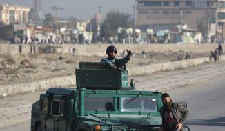 Afghan security forces inspect the site of a suicide attack in Kabul on Nov. 16, just one in a series of attacks by Taliban insurgents and Islamic State fighters over the past two months. (Associated Press)