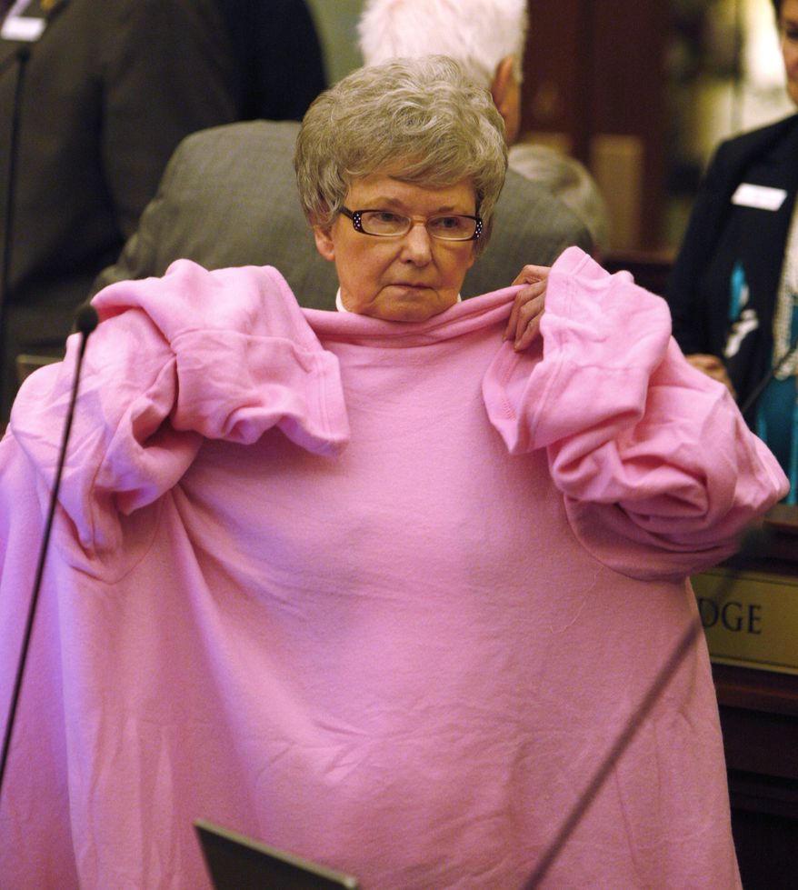 Idaho Senator Shirley McKague tries on a snuggie during a break in the Senate Chambers about an hour before the close of the 2010 session on Monday, March 29, 2010 in Boise, Id.  (AP Photo/Matt Cilley)