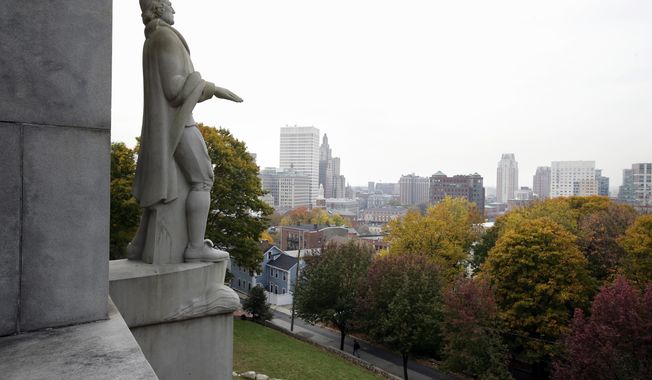 In this Thursday, Nov. 3, 2016, photo, a statue of Roger Williams over looks the skyline, in Providence, R.I. One of Colonial America&#x27;s most important freethinkers has a new role as a marketing tool for the place he settled 380 years ago. Roger Williams founded Providence as a refuge for dissidents experimenting with ideas that formed the backbone of U.S. democracy. Now state leaders are harkening back to his legacy as a draw for businesses and young people looking for a place that matches their ideals. (AP Photo/Steven Senne)