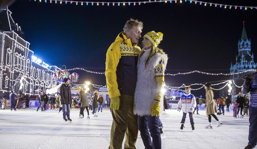 In this Saturday, Nov. 28, 2015 file photo, Olympic figure skating champion and TV presenter Tatiana Navka, right, and her husband Russian presidential spokesman Dmitry Peskov pose at the opening of a skating rink in Red Square in Moscow. Former Olympic ice dancer Navka and her on-ice partner Andrei Burkovsky caused controversy by dressing up in concentration camp uniforms for a dance routine on a popular television show broadcasted on Saturday, Nov. 26, 2016. (AP Photo/Pavel Golovkin, File)