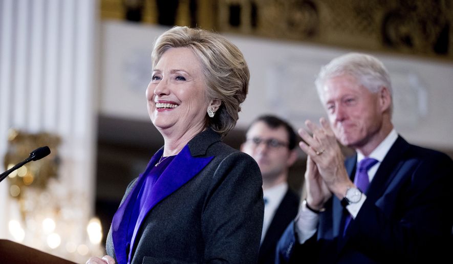 Hillary Clinton, accompanied by former President Bill Clinton, right, pauses while speaking to staff and supporters at the New Yorker Hotel in New York, Nov. 9, 2016. Hillary Clinton introduced singer and UNICEF Goodwill Ambassador Katy Perry on Tuesday, Nov. 29, at the annual event in New York. (AP Photo/Andrew Harnik) ** FILE **