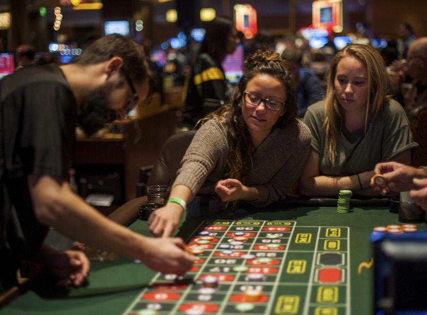 In this Nov. 17, 2016 photo, Ashley Koletta, 23, of Mt. Washington, and Olivia Kluiter, 24, of Greensburg, play roulette at Rivers Casino on the North Shore, in Pittsburgh. (Nate Smallwood /Pittsburgh Tribune-Review via AP)
