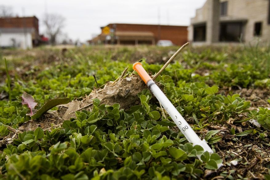 FILE - In this March 24, 2015 file photo, a syringe is pictured along West Main Street in downtown Austin, Ind., in Scott County, Ind. The long decline in HIV infections among white people who inject drugs has stalled, another grim side effect of the nation’s drug abuse epidemic. Health officials released the news Tuesday, Nov. 29, 2016, as part of a call for more use of needle exchange programs. Last year rural Scott County experienced an HIV outbreak, in which more than 100 injection drug users were infected. The state’s governor at the time - Mike Pence, now the vice president-elect - declared a public health emergency and authorized a limited need-exchange program to prevent the virus from spreading further. (Christopher Fryer /News and Tribune via AP, File)