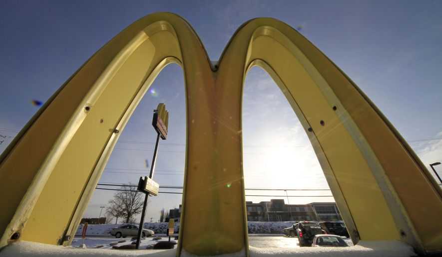 Cars drive past the McDonald's Golden Arches logo at a McDonald's restaurant in Robinson Township, Pa., in this Jan. 21, 2014, file photo. (AP Photo/Gene J. Puskar, File)