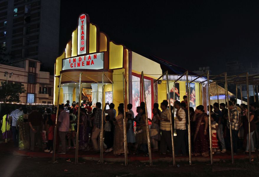 People stand in a queue to enter a movie theater in Kolkata, India, on Oct. 11, 2013. (Associated Press) **FILE**