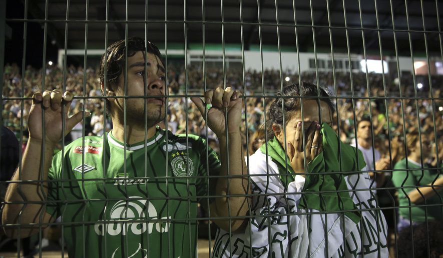 Fans of Brazil&#39;s Chapecoense soccer team cry during a tribute to the players who died in a plane crash in Colombia, at Arena Condado stadium in Chapeco, Brazil, Wednesday, Nov. 30, 2016. Authorities were working to finish identifying the bodies before repatriating them to Brazil. (AP Photo/Andre Penner)