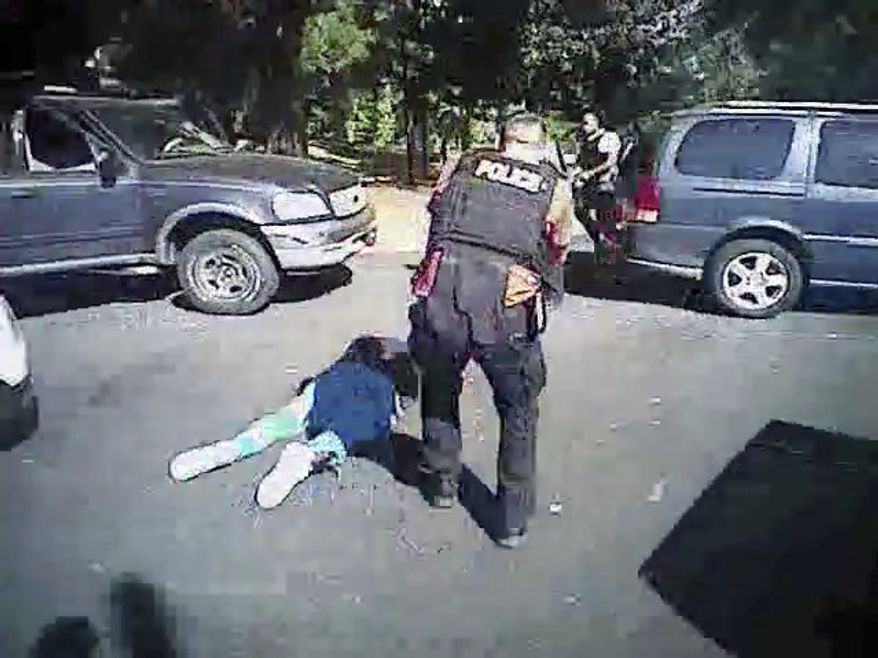 This image made from video provided by the Charlotte-Mecklenburg Police Department on Saturday, Sept. 24, 2016, shows Keith Scott on the ground as police approach him in Charlotte, N.C., on Sept. 20, 2016. Charlotte-Mecklenburg District Attorney Andrew Murray announced Wednesday, Nov. 30, 2016, that the shooting by officer Brent Vinson was justified. Vinson, who is black, shot and killed Keith Lamont Scott on Sept. 20. (Charlotte-Mecklenburg Police Department via AP)