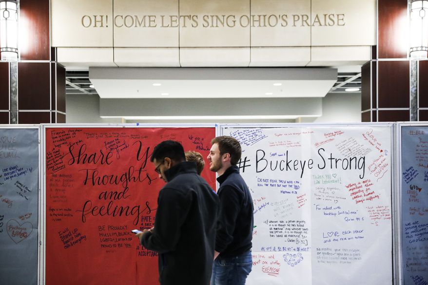 Students mill about The Ohio State University student union Tuesday, Nov. 29, 2016, as a message board covered in community reactions stands in the main hall following an attack at on campus the previous day, in Columbus, Ohio. Investigators are looking into whether a car-and-knife attack at Ohio State University that injured several people was an act of terror by a student who had once criticized the media for its portrayal of Muslims. (AP Photo/John Minchillo)