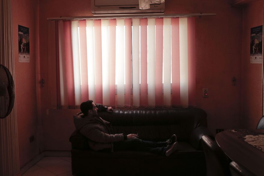 In this Tuesday, Nov. 29, 2016 photo, Ahmed, who is living with HIV, rests at the office of the Roaya Association for Integrated Development, the largest of the few groups in Egypt that look after people living with HIV. Ahmed spoke to The Associated Press on condition that his full name not be used, details of his life not be given and his face not be shown in photos _ a sign of how overwhelming the stigma remains here 30 years after the first case of HIV infection was discovered in Egypt. (AP Photo/Nariman El-Mofty)