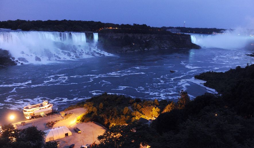 FILE - In this July 22, 2013, file photo, the Canadian side of the American Falls and Horseshoe Falls are illuminated in blue to celebrate the birth of the Duke and Duchess of Cambridge&#39;s son in Niagara Falls, Ontario, Canada. Officials say new energy-efficient LED lighting being unveiled Thursday, Dec. 1, 2016, will provide brighter and more robust color than the halogen technology that’s been used to cast the Falls in rainbow hues for the past 20 years. (AP Photo/Gary Wiepert, File)
