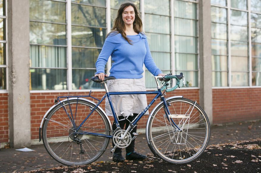 ADVANCE FOR USE SATURDAY, DEC. 3 - In this Nov. 17, 2016 photo, Emily Loberg, 24, who traveled four months solo cross-country by bicycle, poses in from Salem, Ore. Her months-long adventure would take her over the Cascades, near two oceans, across the Great Plains, up the Continental Divide and through 15 states. (Molly J. Smith/Statesman-Journal via AP)