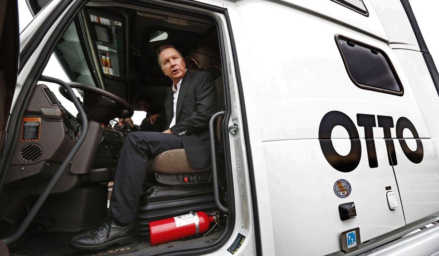 Ohio Gov. John Kasich checks out a self-driving truck made by Otto in Dublin, Ohio, Wednesday, Nov. 30, 2016. As Kasich announced a $15 million investment in advanced self-driving highway technology on Wednesday, he urged Ohioans to push back against old ideas about the state. (Fred Squillante/The Columbus Dispatch via AP)