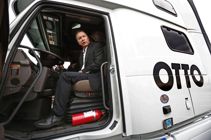 Ohio Gov. John Kasich checks out a self-driving truck made by Otto in Dublin, Ohio, Wednesday, Nov. 30, 2016. As Kasich announced a $15 million investment in advanced self-driving highway technology on Wednesday, he urged Ohioans to push back against old ideas about the state. (Fred Squillante/The Columbus Dispatch via AP)