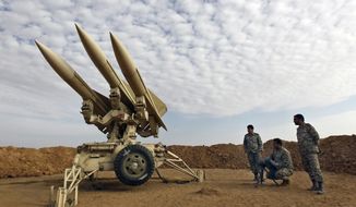 In this photo obtained from the Iranian Mehr News Agency, Iranian army members prepare missiles to be launched during a maneuver at an undisclosed location in Iran on Nov. 13, 2012. (AP Photo/Mehr News Agency, Majid Asgaripour) **FILE**