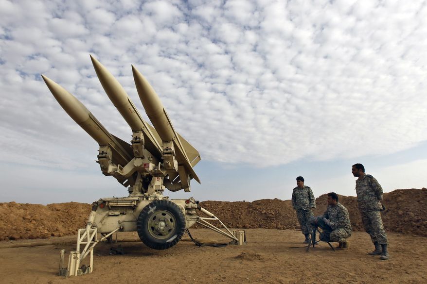 In this photo obtained from the Iranian Mehr News Agency, Iranian army members prepare missiles to be launched during a maneuver at an undisclosed location in Iran on Nov. 13, 2012. (AP Photo/Mehr News Agency, Majid Asgaripour) **FILE**
