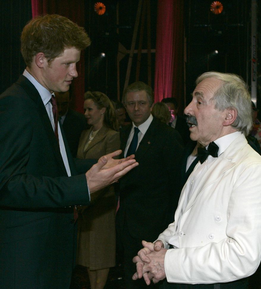 FILE - In this Wednesday, Nov. 12, 2008 file photo, Britain's Prince Harry talks to British actor Andrew Sachs backstage at the Wimbledon Theatre after a charity performance in aid of the Prince's Trust charity, in London. Comic actor Andrew Sachs, known primarily for his role as Manuel in the 1970s situation comedy Fawlty Towers, has died it was announced Thursday, Dec. 1, 2016. He was 86 and had been suffering from vascular dementia. (AP Photo/Alastair Grant, file)