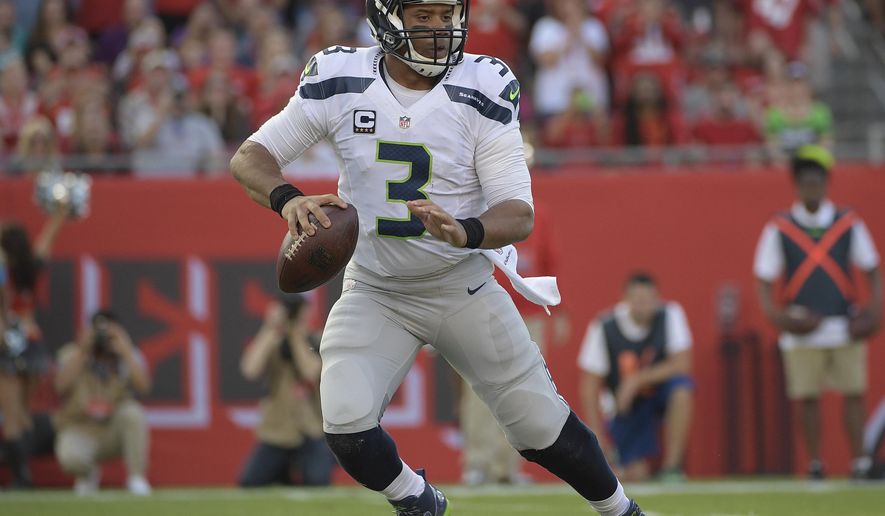 FILE - In this Sunday, Nov. 27, 2016 file photo, Seattle Seahawks quarterback Russell Wilson (3) looks to pass during the first quarter of an NFL football game against the Tampa Bay Buccaneers in Tampa, Fla. For the seventh time in five years, the Panthers and Seahawks will meet on Sunday night, Dec. 4, 2016 each with a different sense of urgency heading into the final month of the regular season. (AP Photo/Phelan Ebenhack, File)