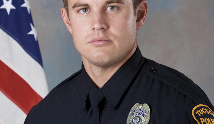 In this undated photo provided by the Tucson Police Department shows police officer Doug Wilfert, one of two police officers wounded Thursday morning, Dec. 1, 2016, as they sought to take Jose N. Barron Gomez into custody on a felony arrest warrant for aggravated assault with a dangerous instrument. Gomez, 27, was killed in the shooting. (Tucson Police Department via AP)